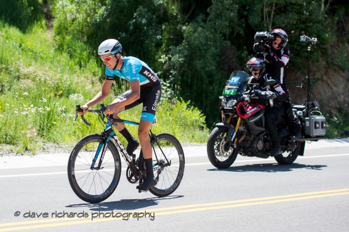 The TV moto follows Jordan Cheyne (Elevate-USA KHS Pro Cycling) up the steep climb during the Prologue at Snowbird, 2019 LHM Tour of Utah (Photo by Dave Richards, daverphoto.com)