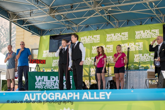 Two young men sing the Star Spangled Banner to lead off Stage 2 - Brigham City to Powder Mountain Resort, 2019 LHM Tour of Utah (Photo by Dave Richards, daverphoto.com)