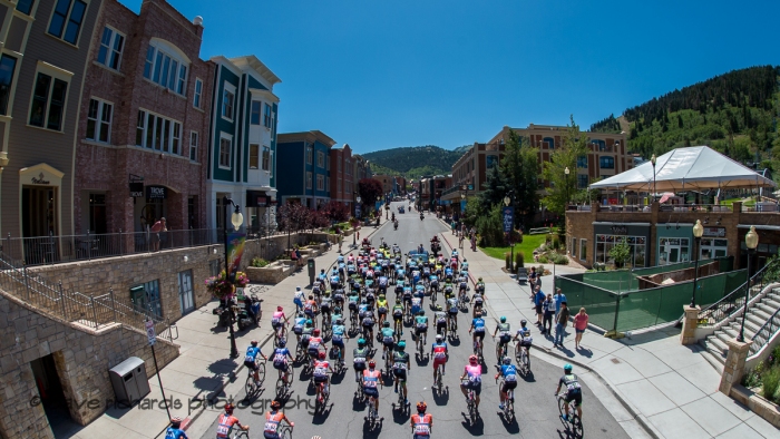 The peloton rolls up Main Street Park City  during the neutralized start of Stage 6, 2019 LHM Tour of Utah (Photo by Dave Richards, daverphoto.com)