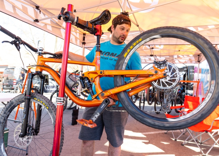 Kona Bicycles employee tuning up one of their demo bikes at the 2022 Hurricane MTB Festival. Photo by John Shafer, Photo-John.net