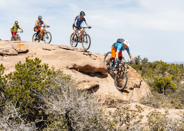 Mountain bikers playing follow-the-leader behind local, Clayton Coleman, at the 2022 Hurricane MTB Festival. Photo by John Shafer, Photo-John.net