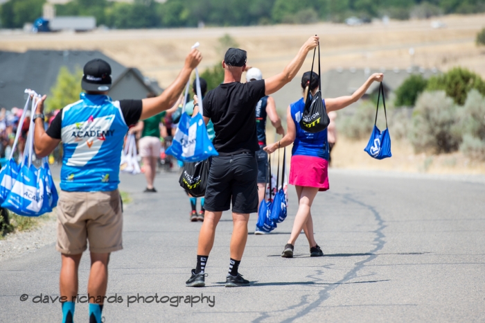 Soigneurs line up by the side of the road to hand out feedbags to the riders on Stage 2, 2018 LHM Tour of Utah cycling race (Photo by Dave Richards, daverphoto.com)