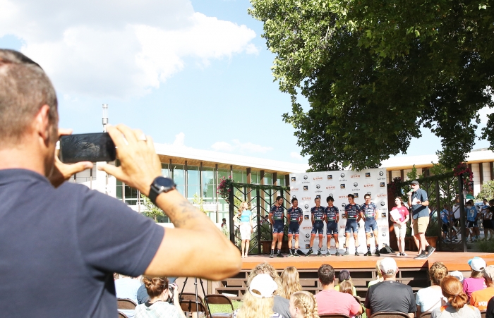 The Directeur Sportif of Nipoo-Vini Fantini-Europa Ovini multi tasks taking photos for their team social media.  2018 Tour of Utah Team Presentation, August 4, 2018, Cedar City, Utah. Photo by Cathy Fegan-Kim, cottonsoxphotography.net