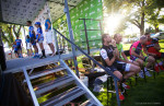 Cadel Evans shows Chris Horner photos of his children as Garmin-Sharp goes up on stage. Photo by Cottonsoxphotography.com