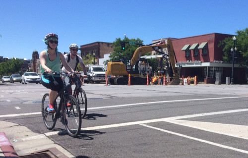 What will the next mayor of Salt Lake City do for cycling?  Here, 2 cyclists ride through the streets of Salt Lake City. Photo by Dave Iltis