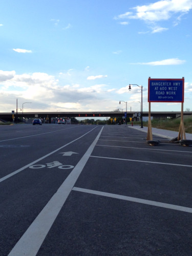 Redwood Road is part of the Wasatch Front Regional Council's Bicycle Priority Network. This section, by the Bangerter Highway has bike lanes (although the one pictured here is too narrow). UDOT is proposing to remove lanes from 10440 S to 12600 S. Photo by Lisa Hazel