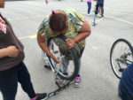 Learning to change a tire. Photo by May Romo and Merecedes Rodriguez