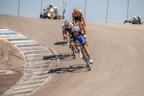 Racers are deep into the Corkscrew turn heading towards the finish line on the Laguna Seca racetrack, Stage 4, 2016 Amgen Tour of California.