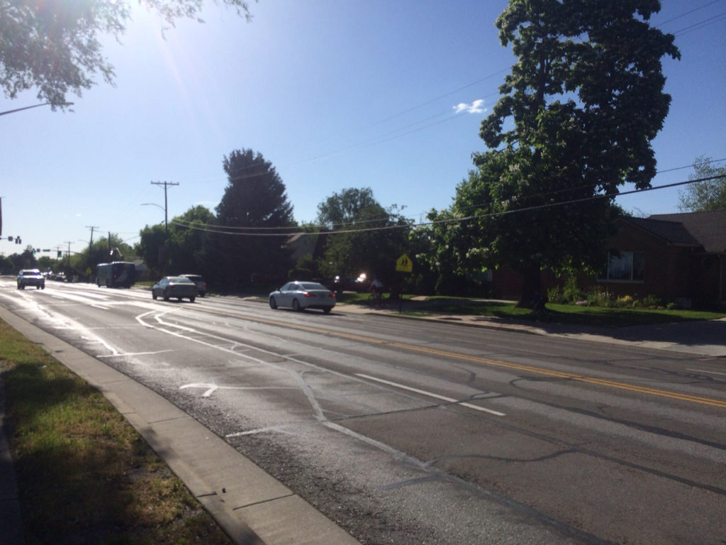 A father and child are forced to ride on the sidewalk since there are no bike lanes on 2100 S. Mayor Biskupski decided today to keep the status quo of a less safe 2100 S. Photo by Dave Iltis