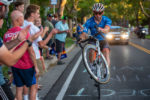 Ty Magner (Rally UHC Cycling) rides a wheelie up State Street. Stage 4, 2019 Tour of Utah. Photo by Steven L