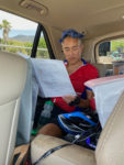 Doug Fujii, with ice on his head and ever present water bottle nearby, studying the route between pulls near Peeples Valley, AZ in the 2021 Race Across the West – photo by Laura Hill Temmerman