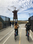 2 cyclists ride over I-80 on the Berkeley Bike Bridge. Photo by Dave Iltis