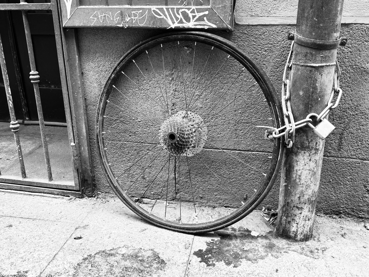 A lonely bicycle wheel in Madrid, Spain. Photo by Dave Iltis