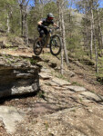 Derrick launches at Leatherwood. Bentonville Mountain Biking. Photo by Tom Jow